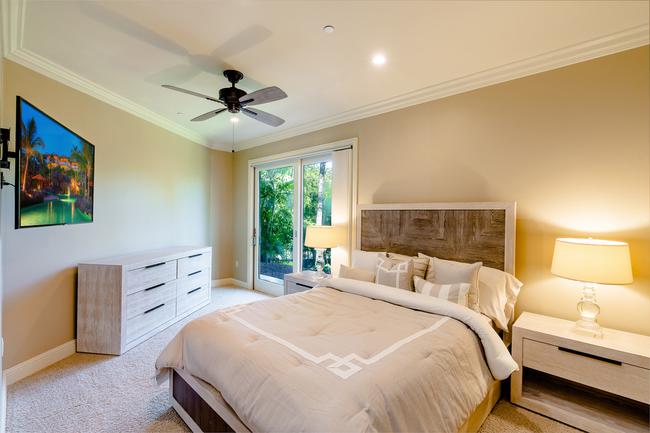 The downstairs master suite has been thoughtfully divided up into two bedrooms, this photos shows the 4th bedroom, each with lanai access!